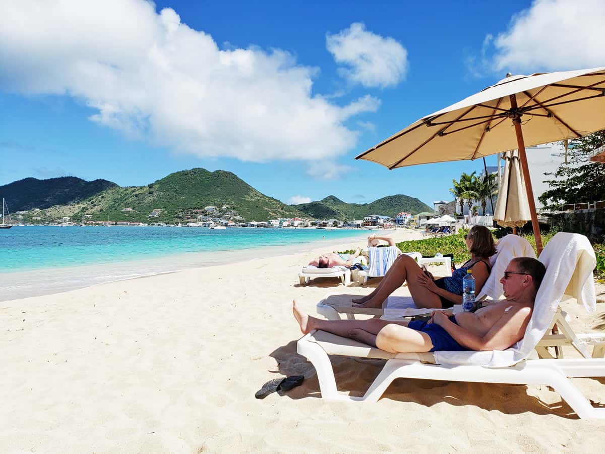 Guests relaxing on the beach at Le Petit Hotel on St. Martin