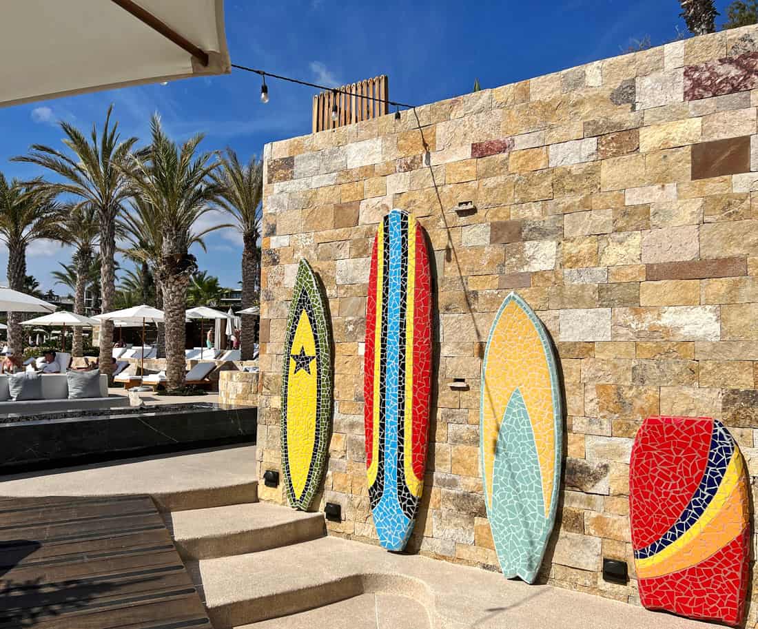 Colorful tiled surfboards decorate steps down to Chileno Bay Resort's beach club