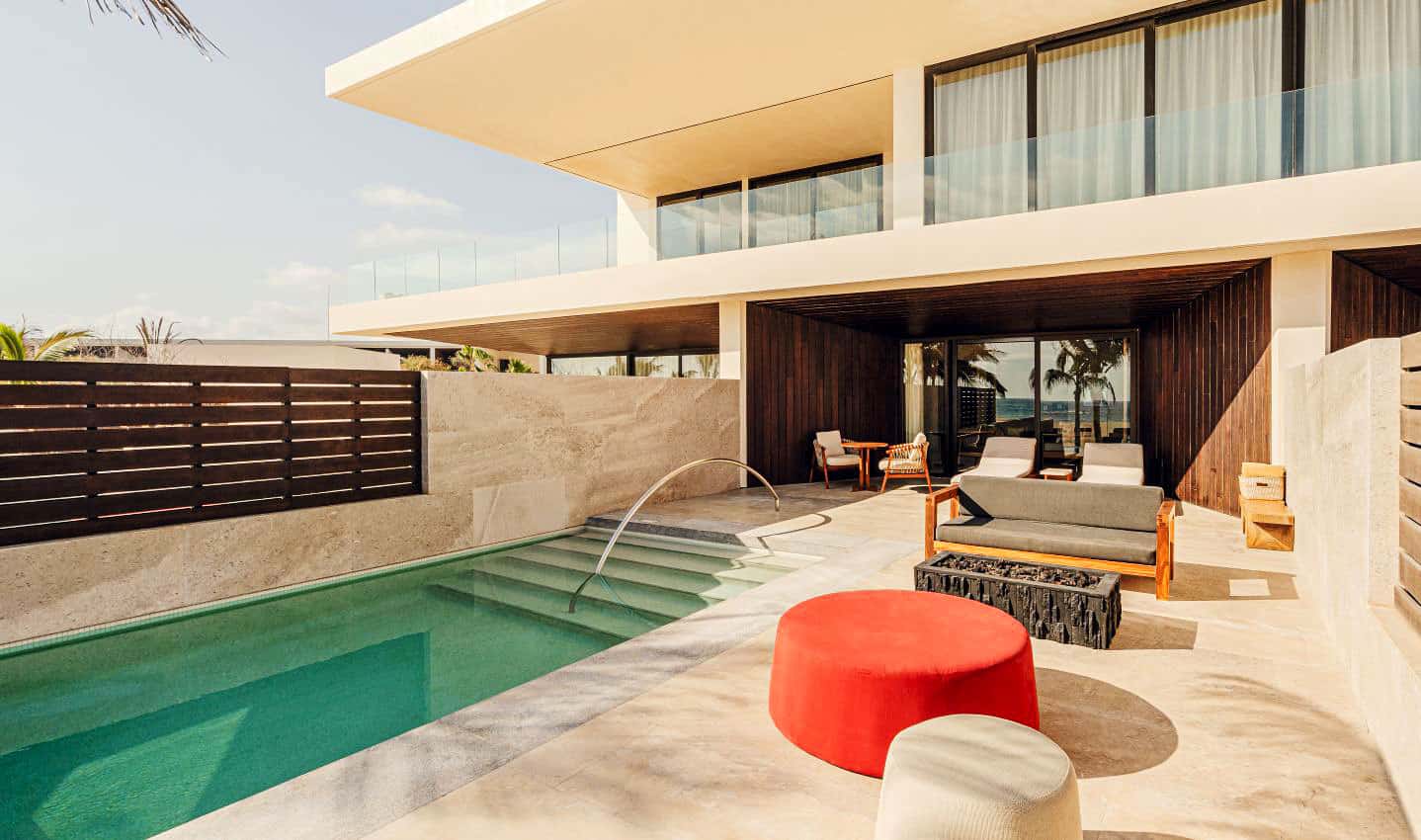 A red pouf decorates the terrace of a Nobu Los Cabos Oceanfront Junior Suite with a Private Pool 
