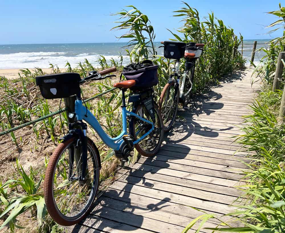 E-bikes on a wooden path by a Porto beach
