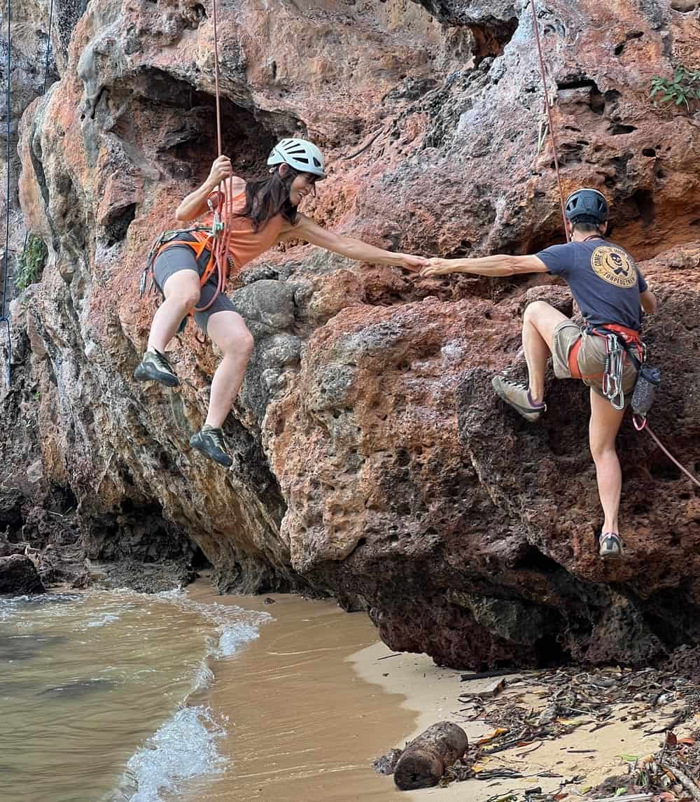 Couple rock climbing in Railay, Thailand