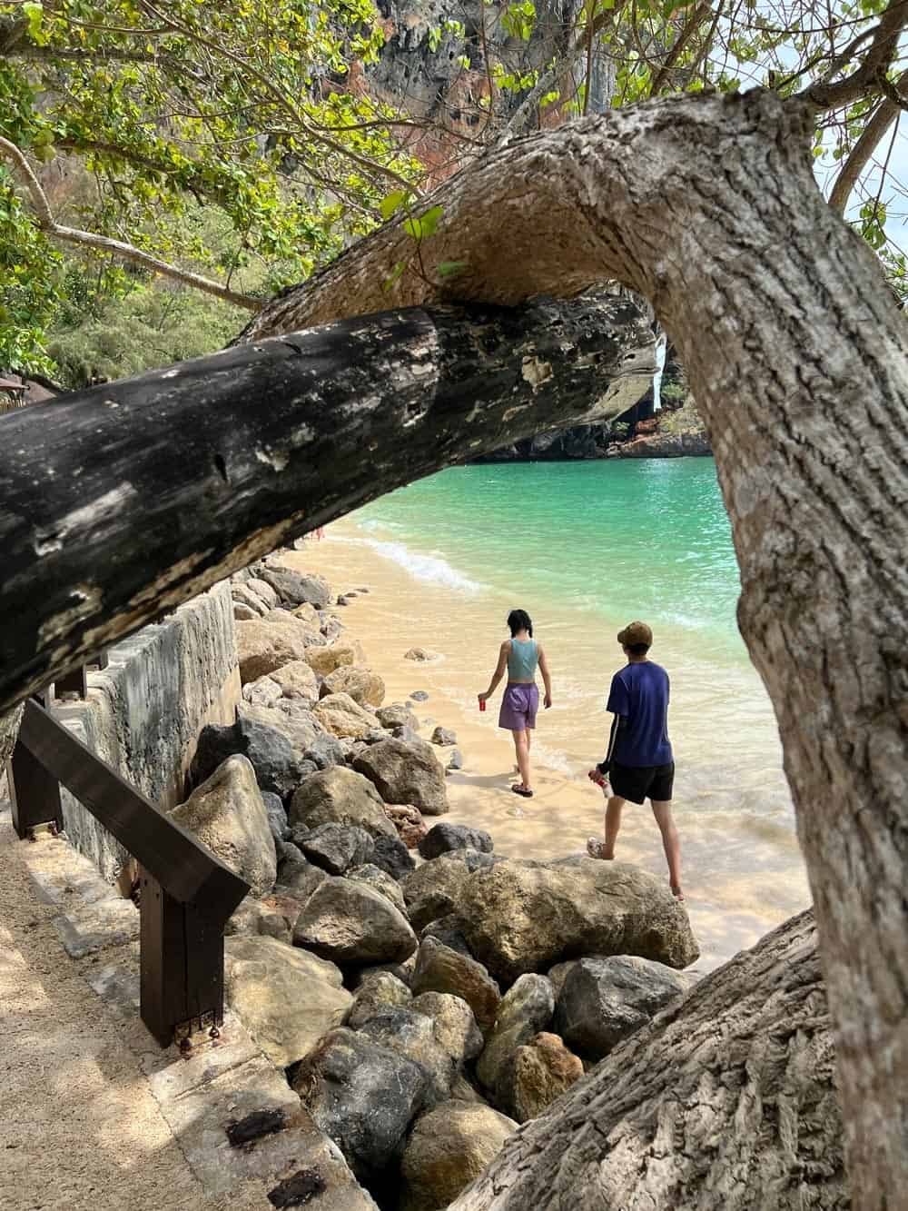 Couple walk on the sand on Phranang Beach