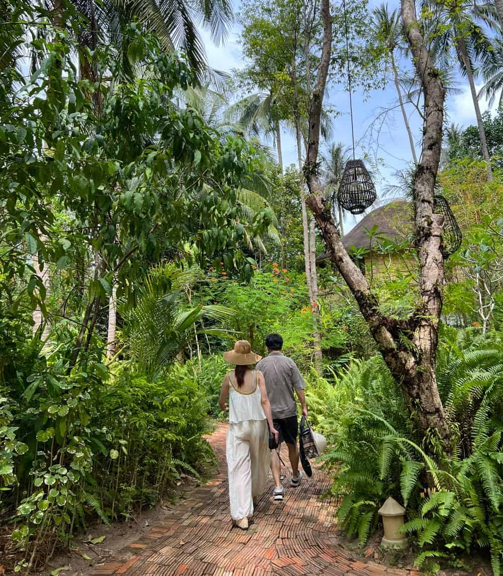 Couple walking along path through Rayavadee greenery