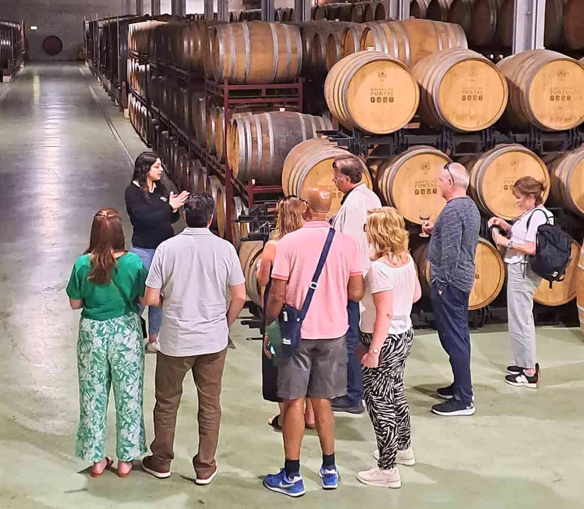 Our group of eight touring the barrel-filled wine cellars at Quinta de Santa Eufemia