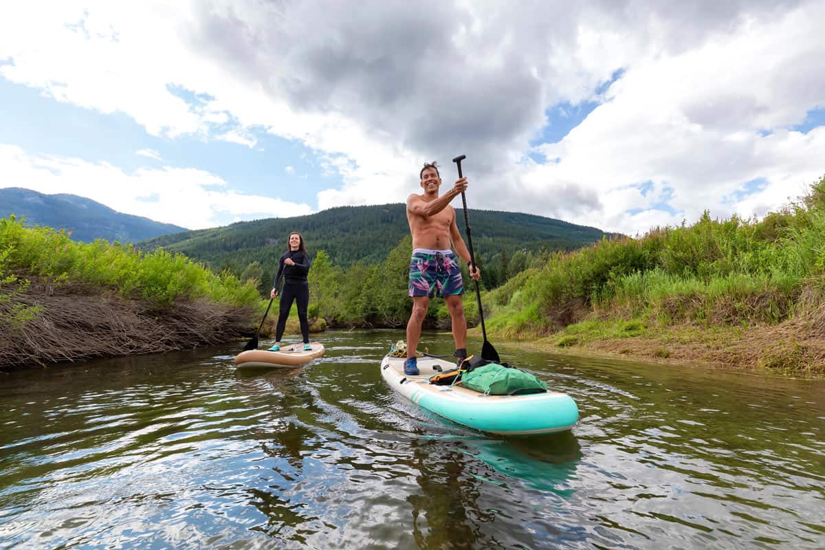 A couple paddleboards in Whistler along the River of Golden Dreams