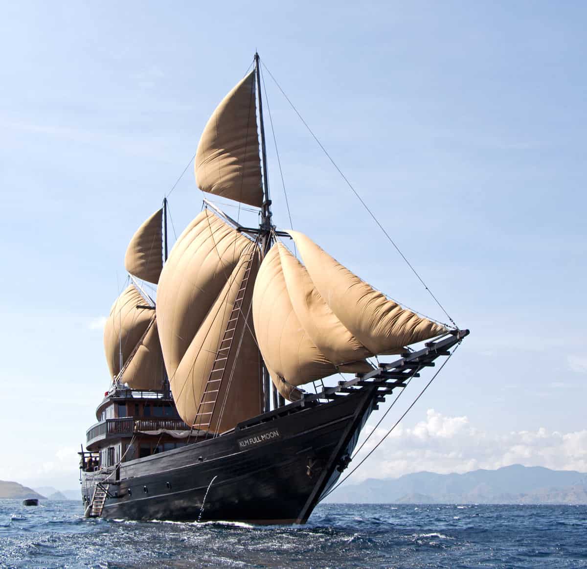 Deluxe Alila Purnama phinisi yacht with brown sails in Indonesia