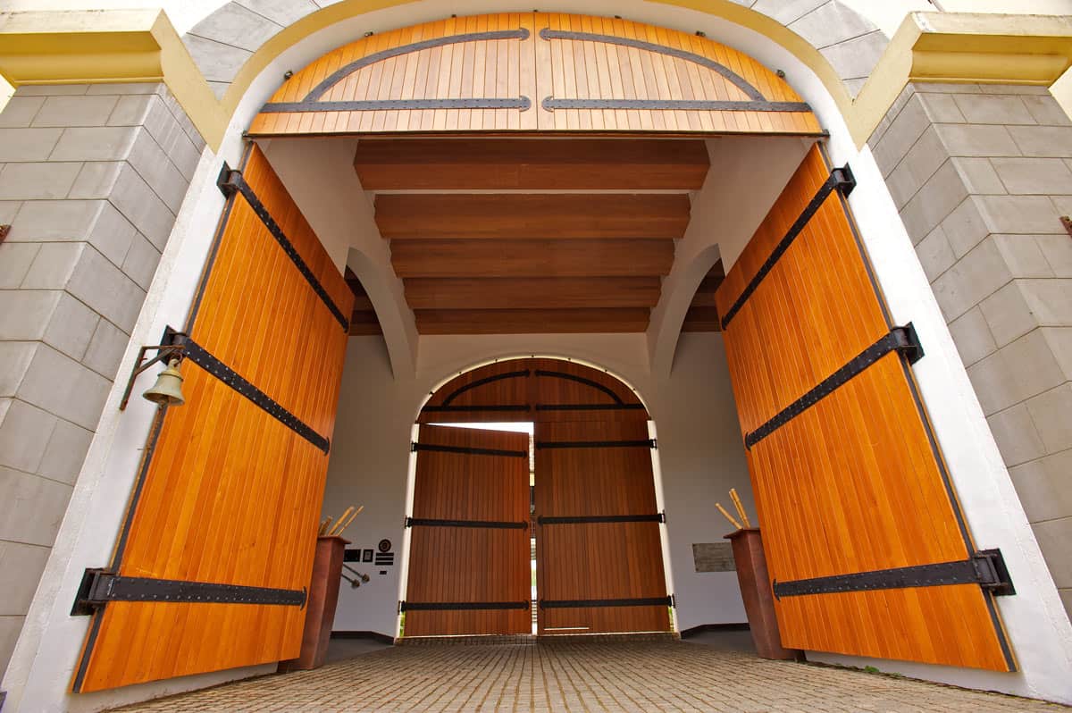 Grand wooden entrance gates at The Fortress Resort & Spa