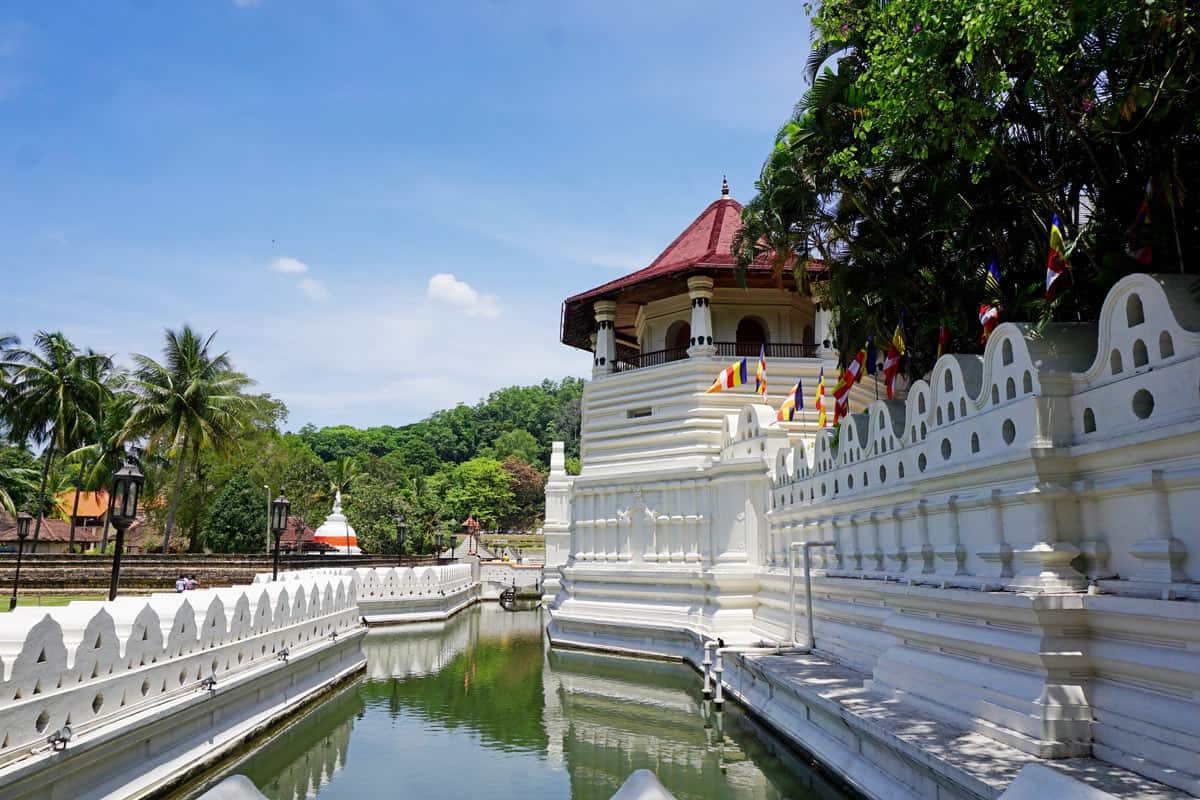 A moat encircles the white-walled Temple of the Tooth in Kandy