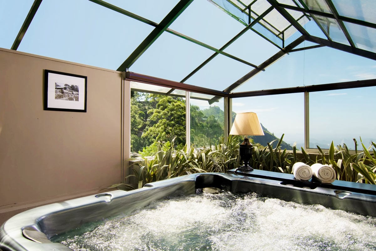 Private Jacuzzi in a glass nook off the Junior Suite at EKHO Ella, with sweeping mountain views